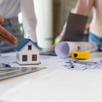 Group of young architects colleagues brainstorm design work on blueprint planning ideas of construction projects. Construction engineering design inspector team working in the office.
