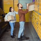 Two busy people stacking a box of stuff in a storage locker while standing near a car SSUCv3H4sIAAAAAAAACpxTy47cIBC8R8o/jDgHCczDkF+JcmjzWKP1mJGNN1qN5t+D8SPMJtpDbu7q6u5yd3H/+uVyQR3MwaDvl/sa5TgMwzKnCVKIY4bJtx2f3GjdVCNvE5OkBiDUkbMhxSnAUIMdJNOPcHUZHJdhWOFHSaI5QVpmN1daYIDre47ZUW4nB9c5hVJ/onO/pOSmOUXzmnF6st0tziHd+pjiXCfAxs6d9EqDgeResugnFceGfmzx5UiUZK7IKYT21puepSvYAW3N/6ty+/h5Cn9xo1k3cn9Uqic3ONg2t2tE0nnROuZxJ7TEXFiHO+4pBiZb2wCxrdTHZASNY8JqwEqKDnMiCAbbcSxF6wU3RjALJ1lxCsA8wY0Eh7nkBmumHaaa5gHCKtvoon8TjV5/5dNcyz53ubDYEKv9vkUDw0pg1T/dpmDC+FKVxdQX/x1lJi5jmt7rHaIhxht0w+oOn3u6A+9hnjPdHnh98uz2eK3mjDGVVe5dkc2eWEPKWKOY4A1TirZcCoZq4/Yh9ylyDoHLbYhg3Tr0vPtpaSoVU22rhTjv/+zugyD5H8JHoxeKkrStenz0fOFoxg7z/2X/laAIJ82WP8y6evEa8rjP9Gva6E/1a0bE3vfpqefZwf7rqSPghnPXEdx6yGb0KnuYGI99SyXxjfRUmvPeTxNR0677oooW/+2zwqof+RYa2TiHWa7PXS3H2fUCG6MtpcCAapWrHr8BAAD//wMAqm9yxhQFAAA=