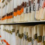 various medical record charts and folders in cabinet and on shelve sorted alphabetically and numerically